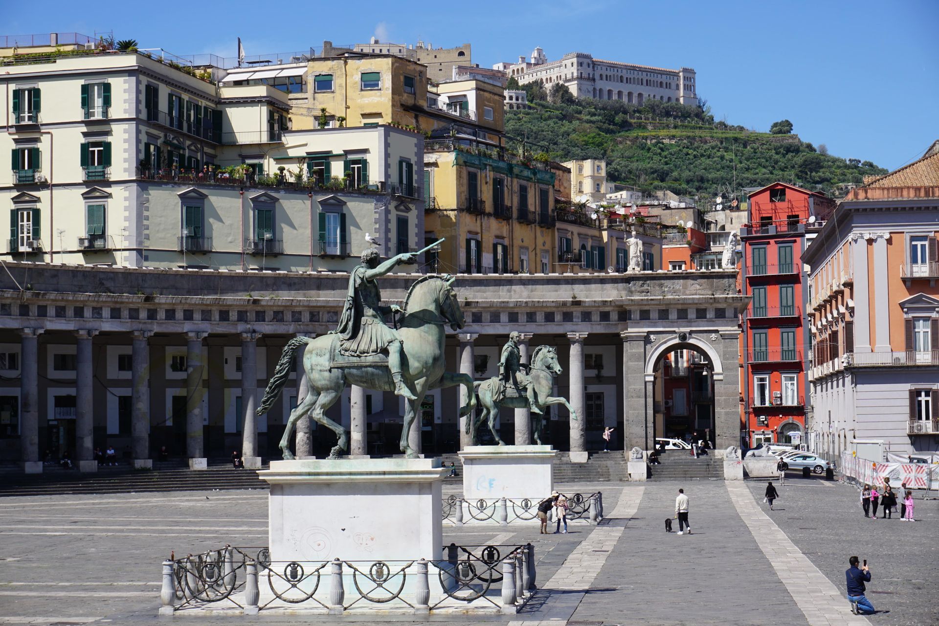 A statue of a man riding a horse in a city square