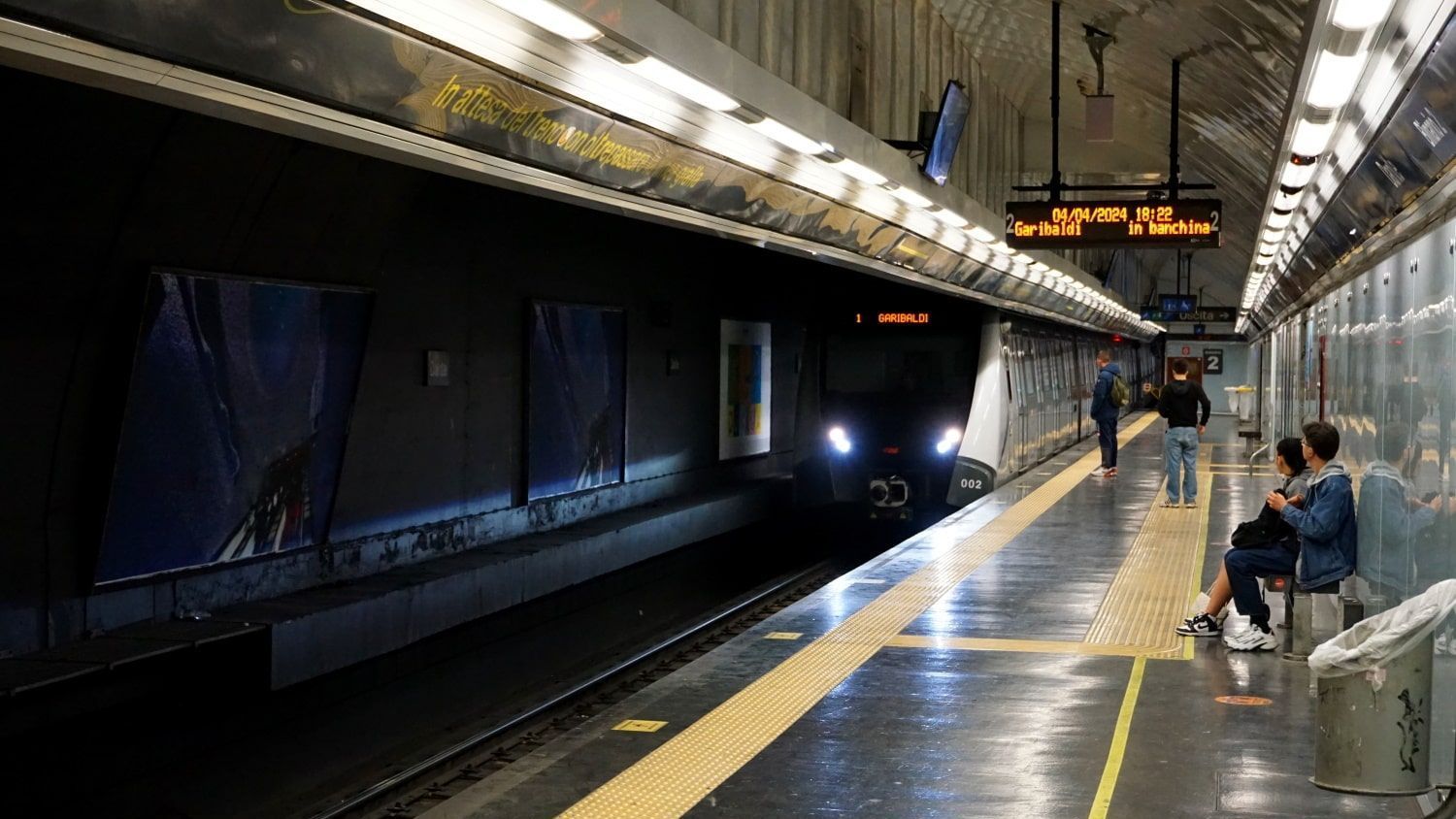 People waiting for a train at a subway station in Napoli