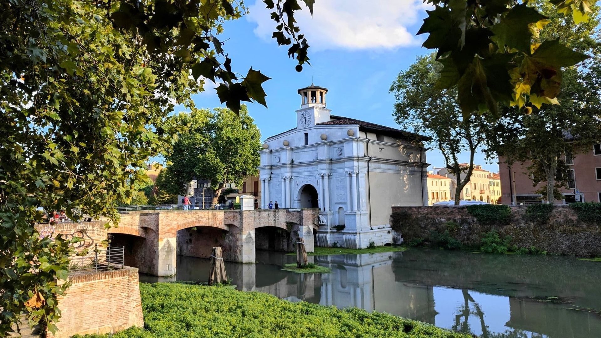 A bridge over a river with a building in the background