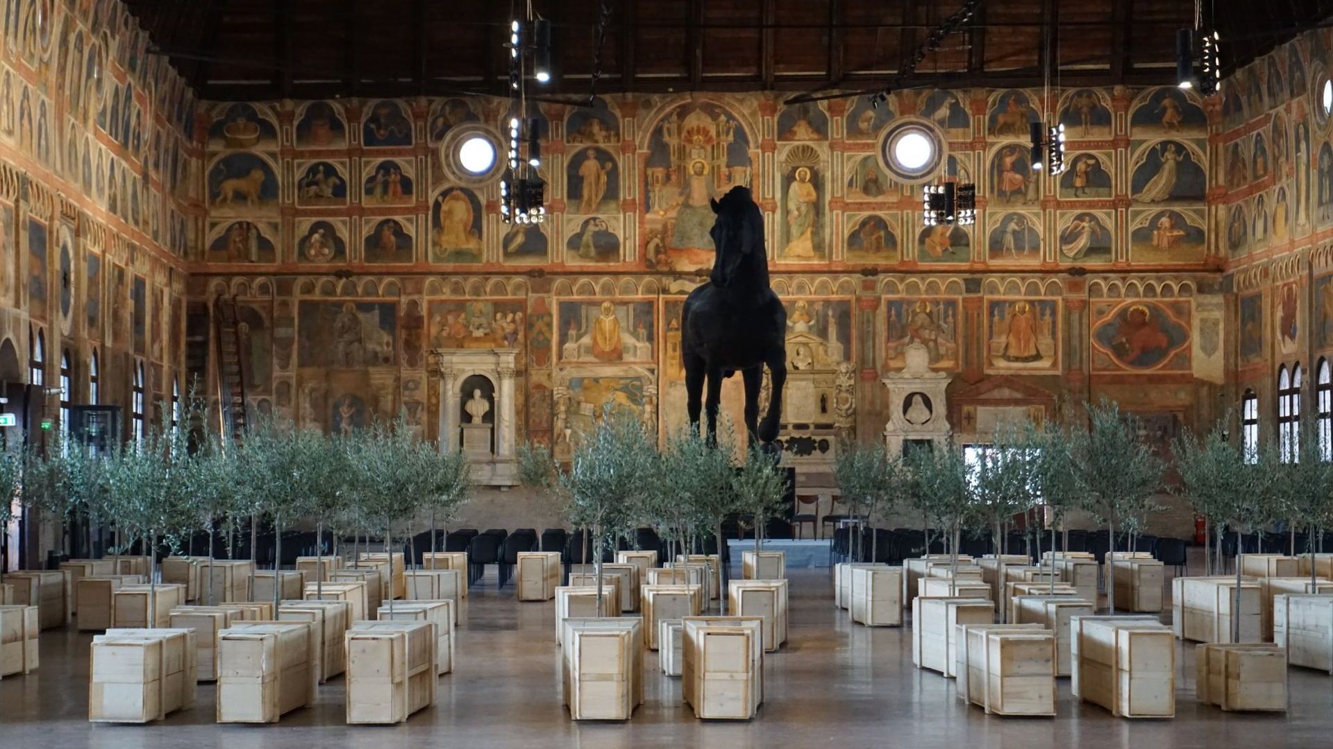 A large room with a statue of a horse in the middle