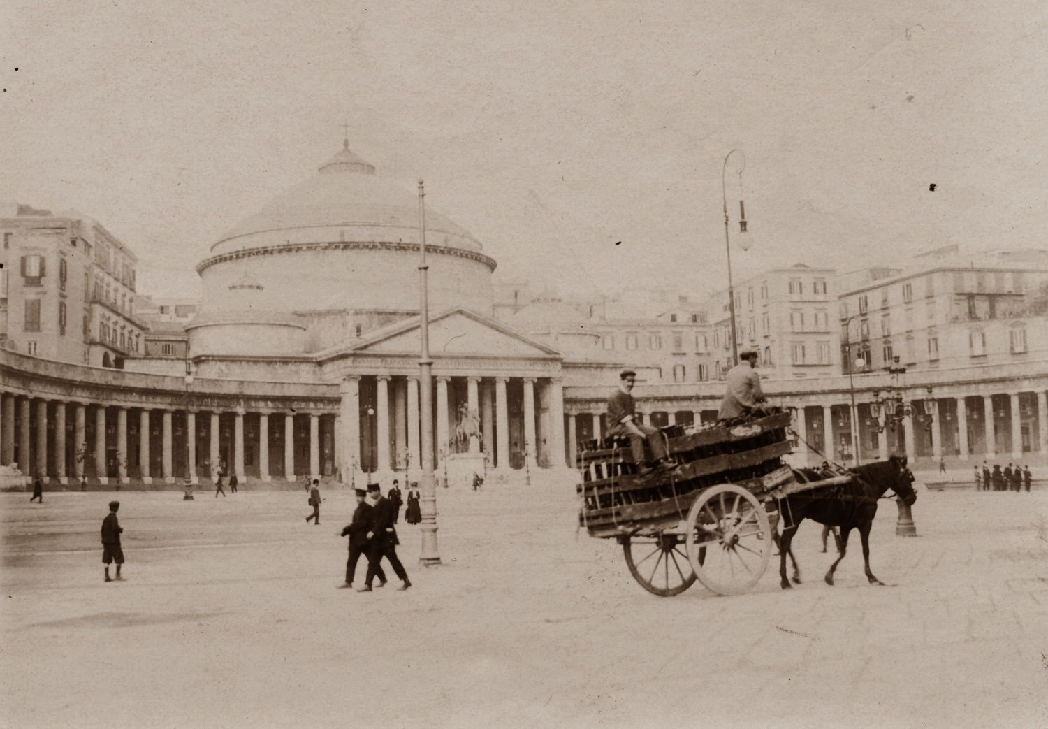 A black and white photo of a horse drawn carriage