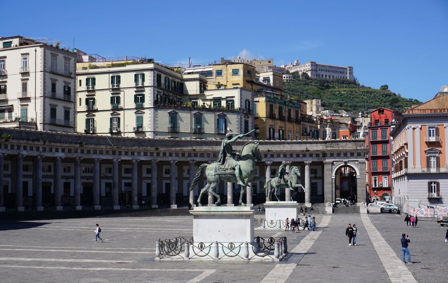 A statue of a man on a horse in a city square