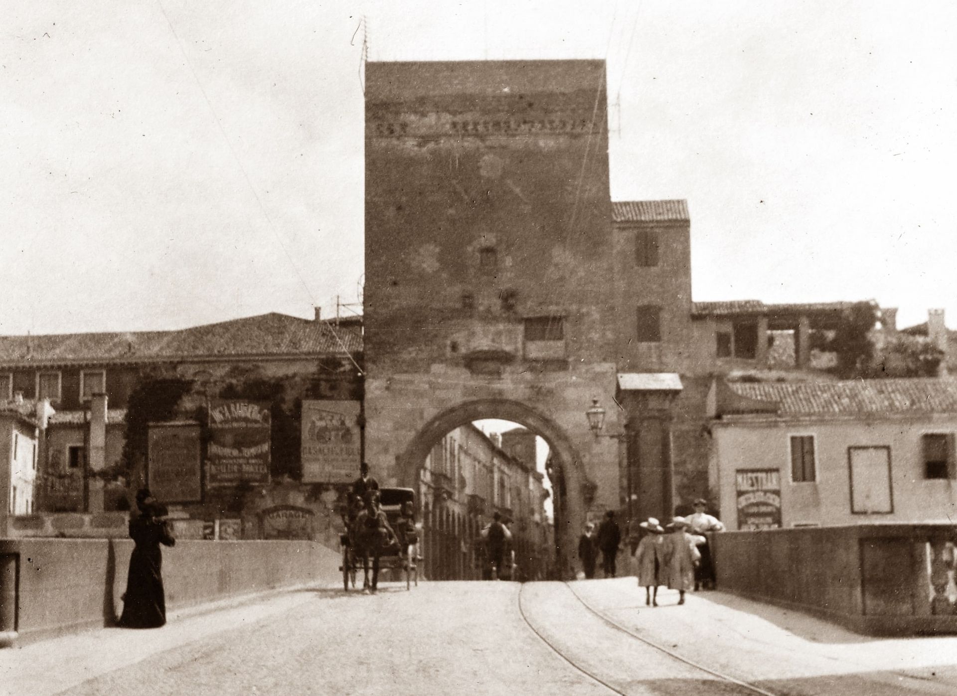 A black and white photo of people walking in front of a building with a sign that says ' eline ' on it