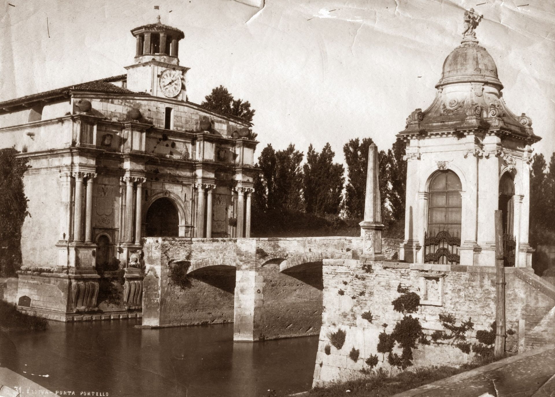 A black and white photo of a bridge and a building