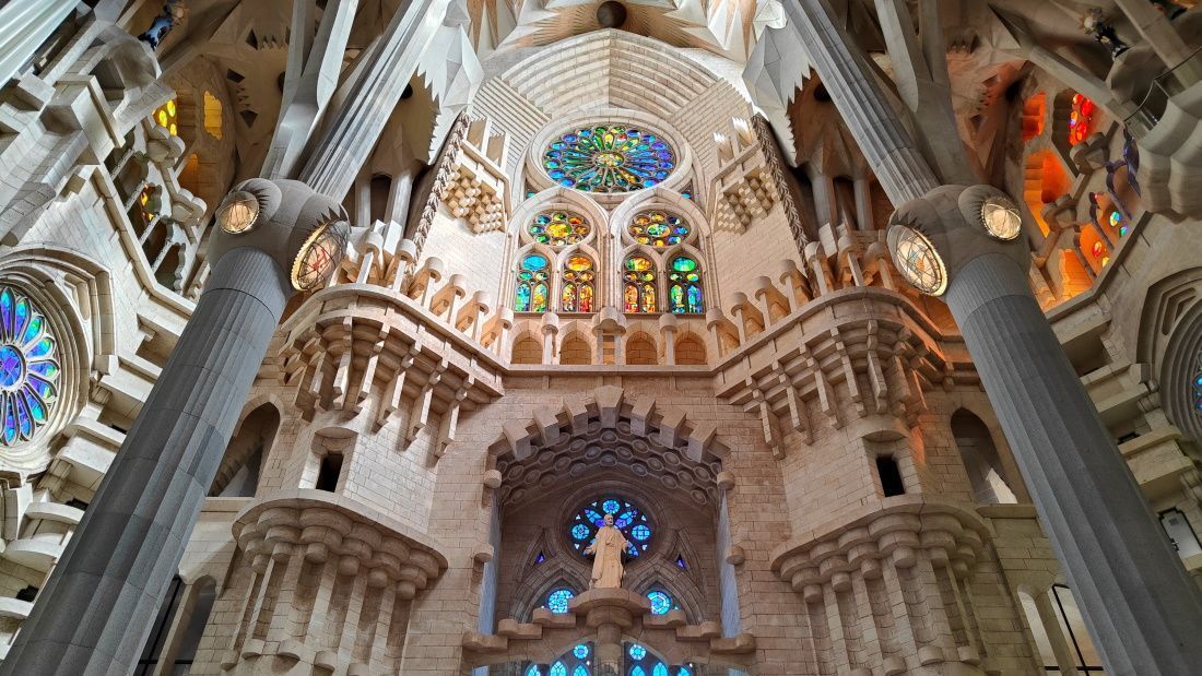 Barcelona Sagrada Familia Looking up at the ceiling of a church with stained glass windows