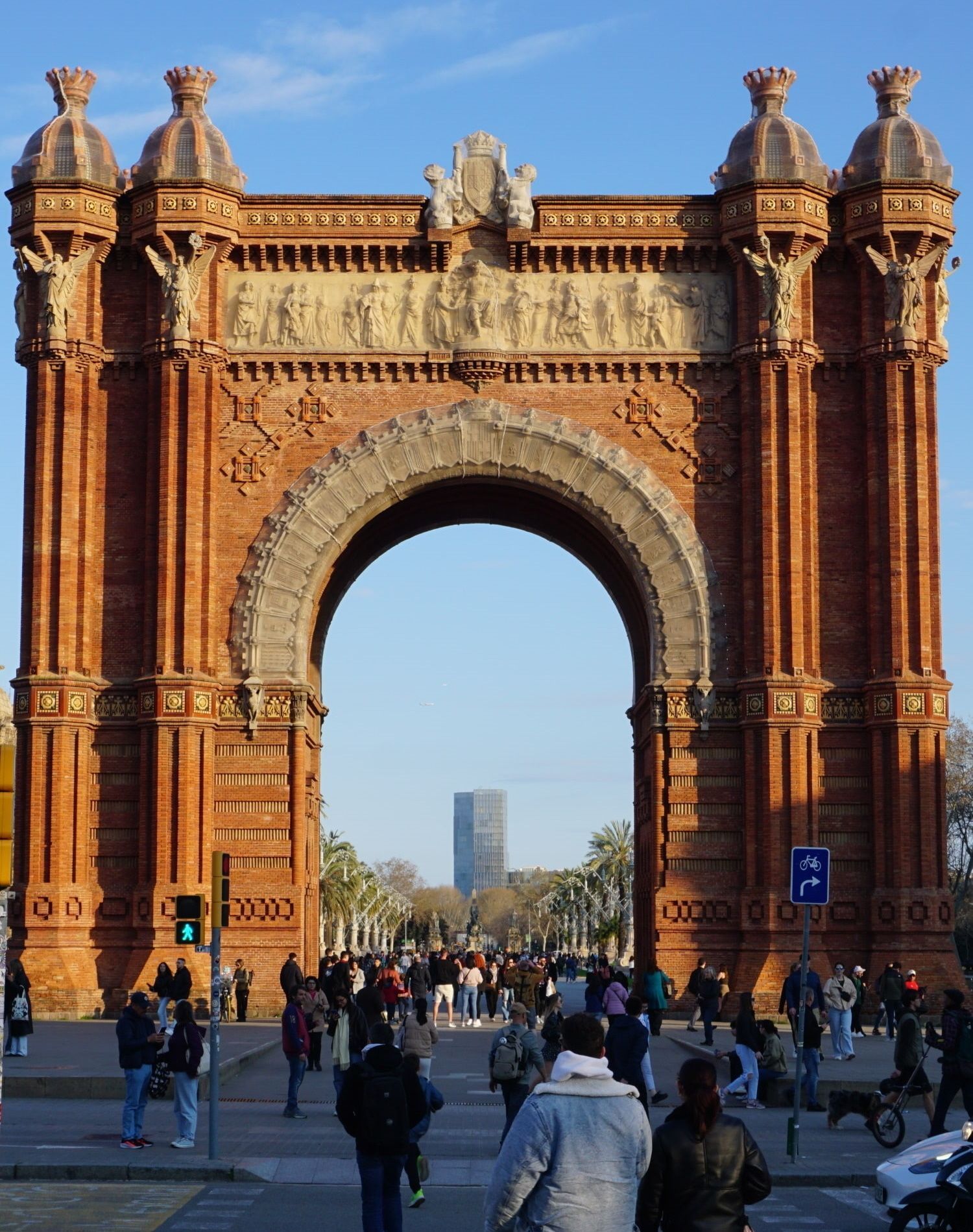 A large brick archway with people walking underneath it