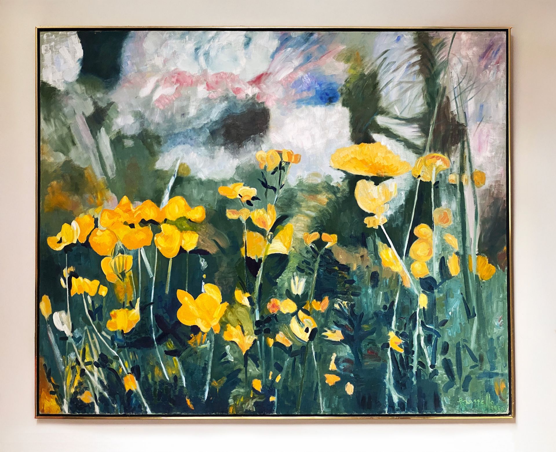 A painting of yellow flowers is hanging on a wall.