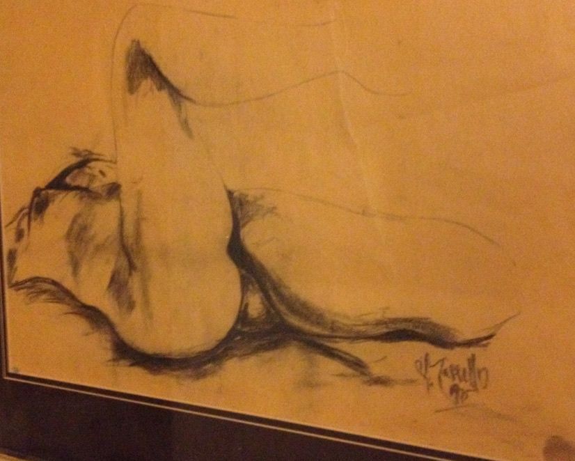 A drawing of a woman laying down with the letters k. written on the bottom