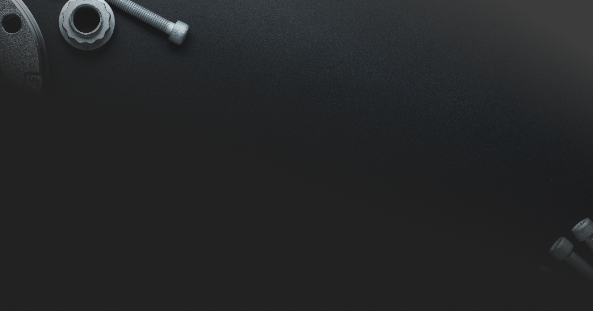 Overhead view of metal hardware pieces on a dark surface. | Destiny Vehicle Solutions