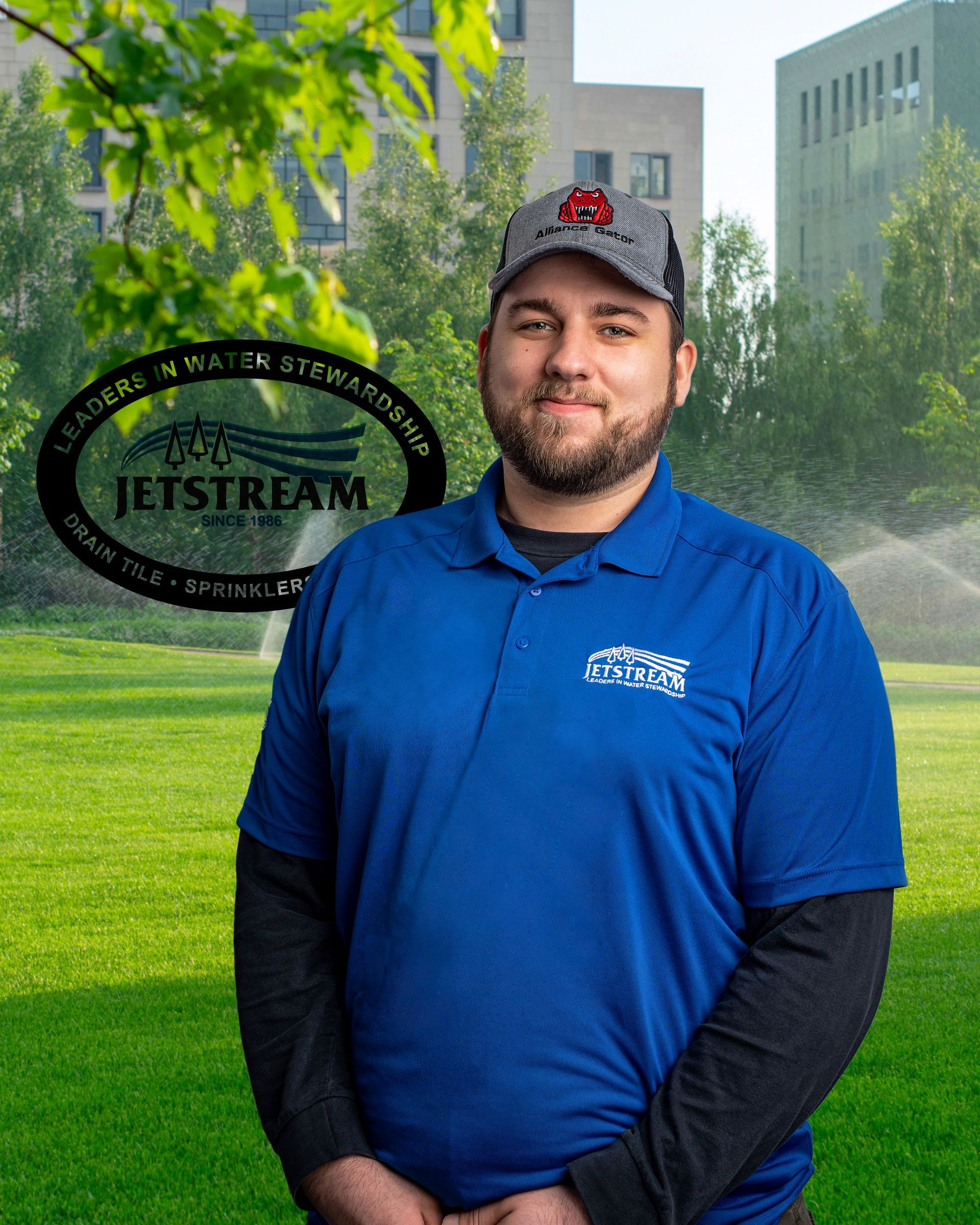 A man in a blue shirt is standing in front of a jetstream logo.