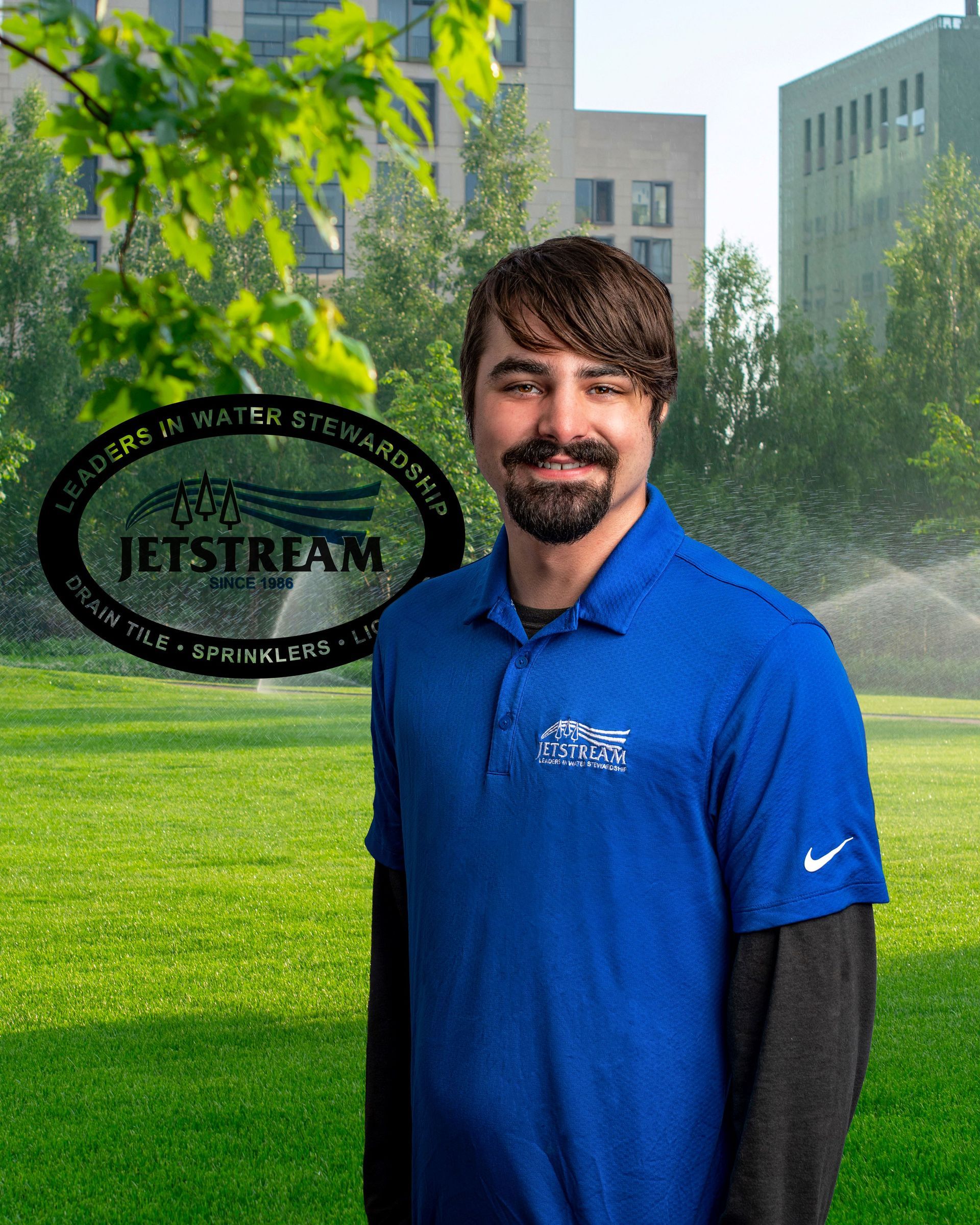 A man in a blue shirt is standing in front of a sign that says jetstream
