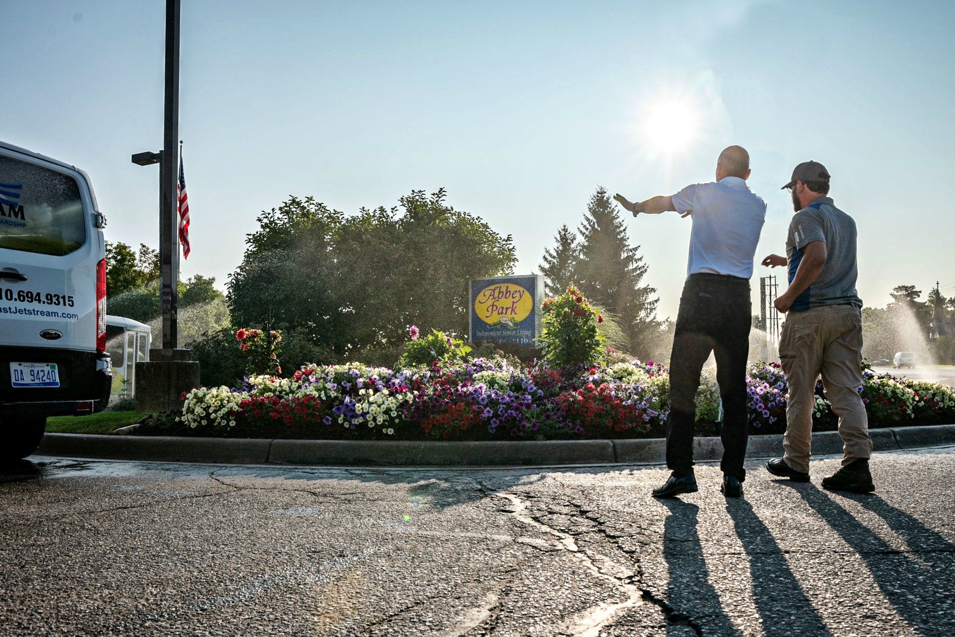 Two men are standing in front of a sign that says bass pro shops
