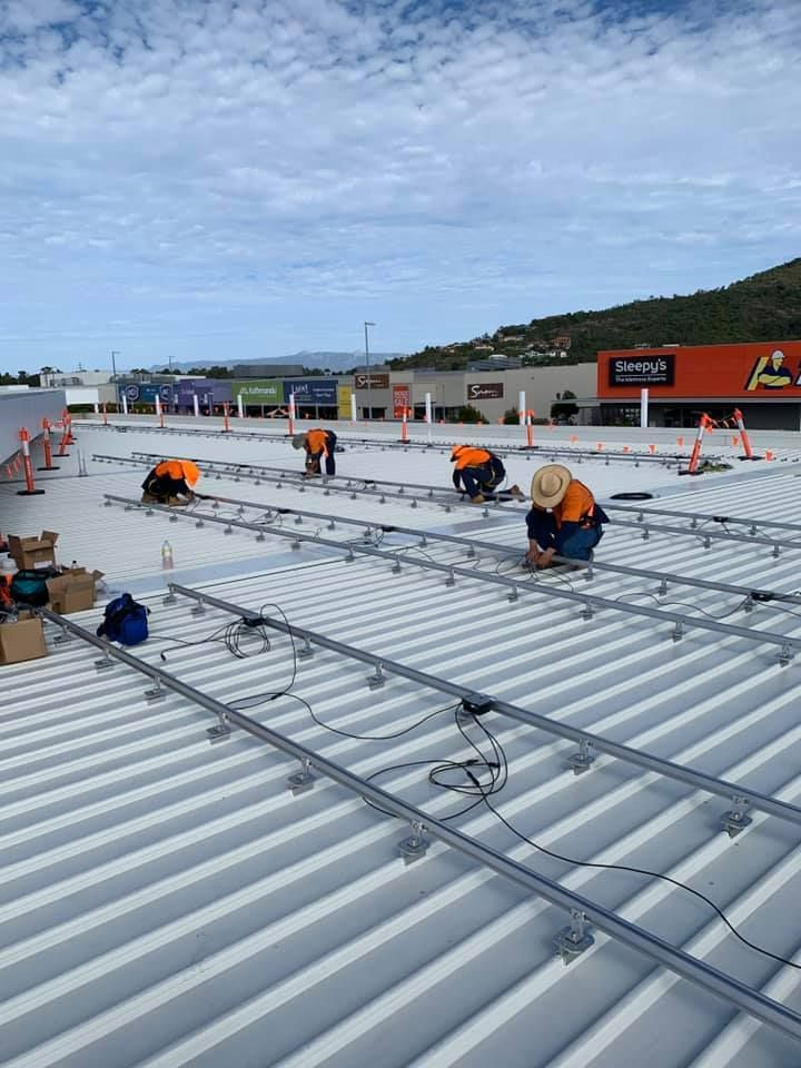 A Group Of People Are Working On The Roof Of A Building  — Waltlec Industries In Garbutt, QLD