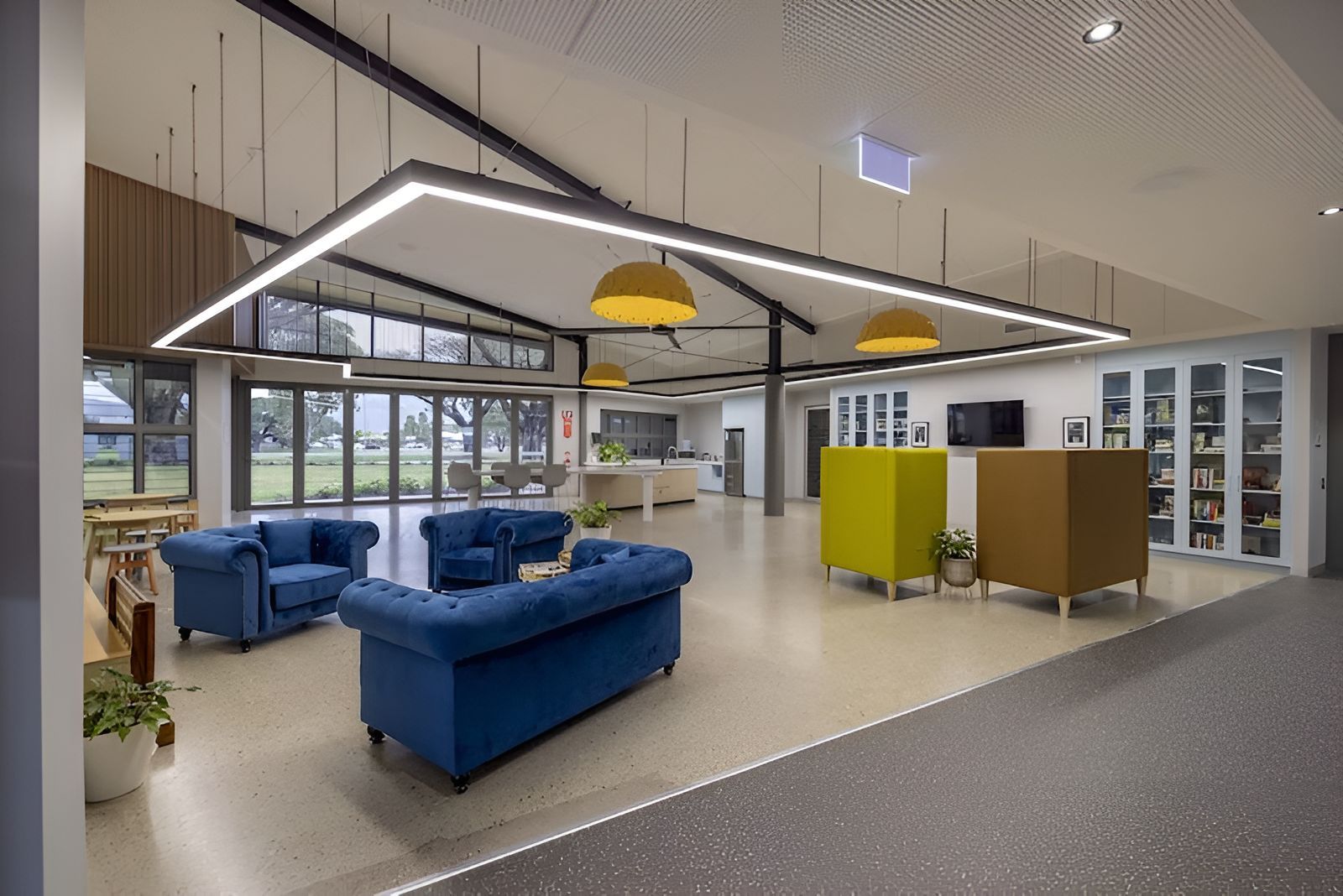 A Large Room With Blue Couches And Chairs In It — Waltlec Industries In Garbutt, QLD