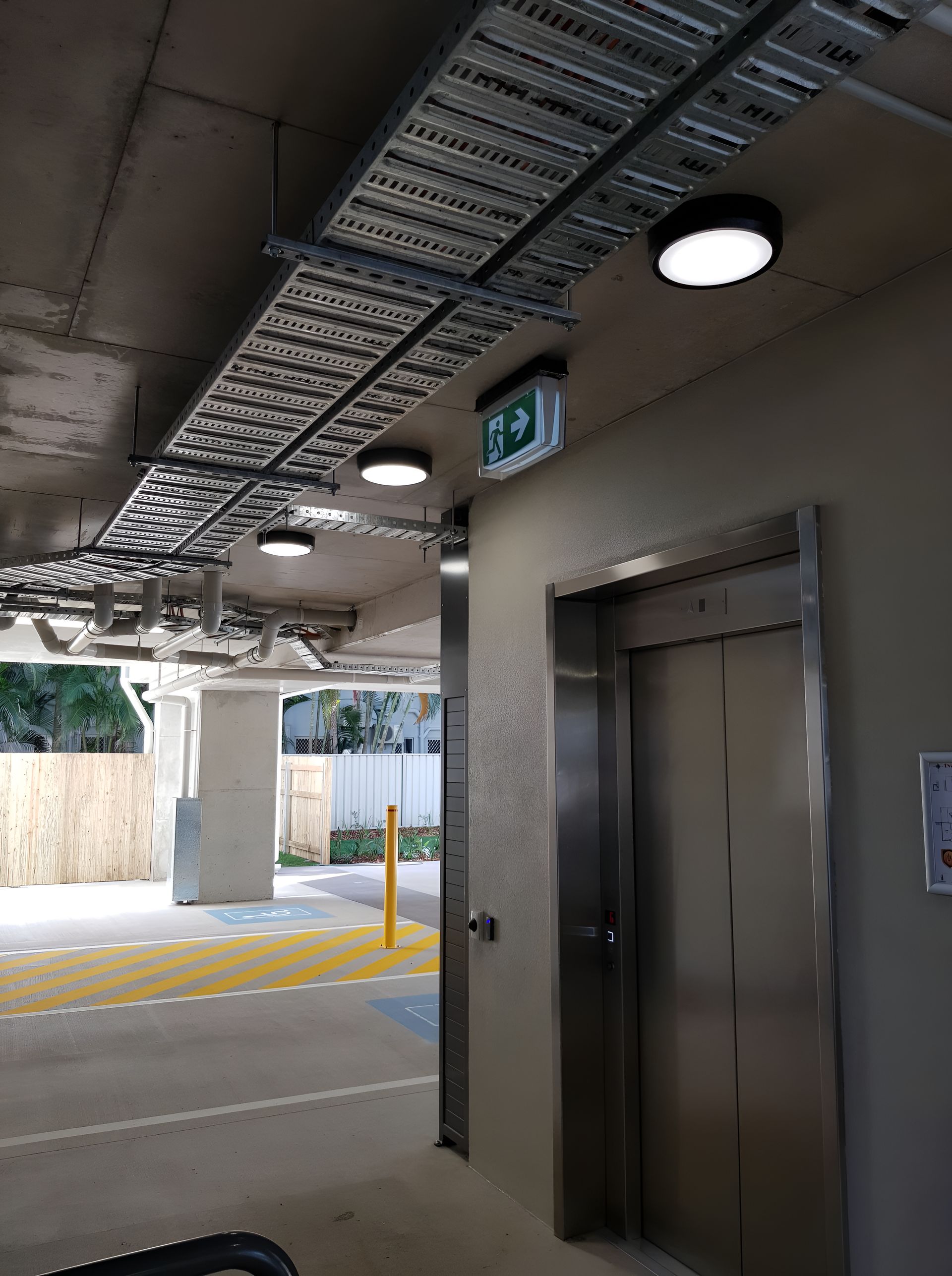 A Stainless Steel Elevator Is In A Parking Garage  — Waltlec Industries In Garbutt, QLD