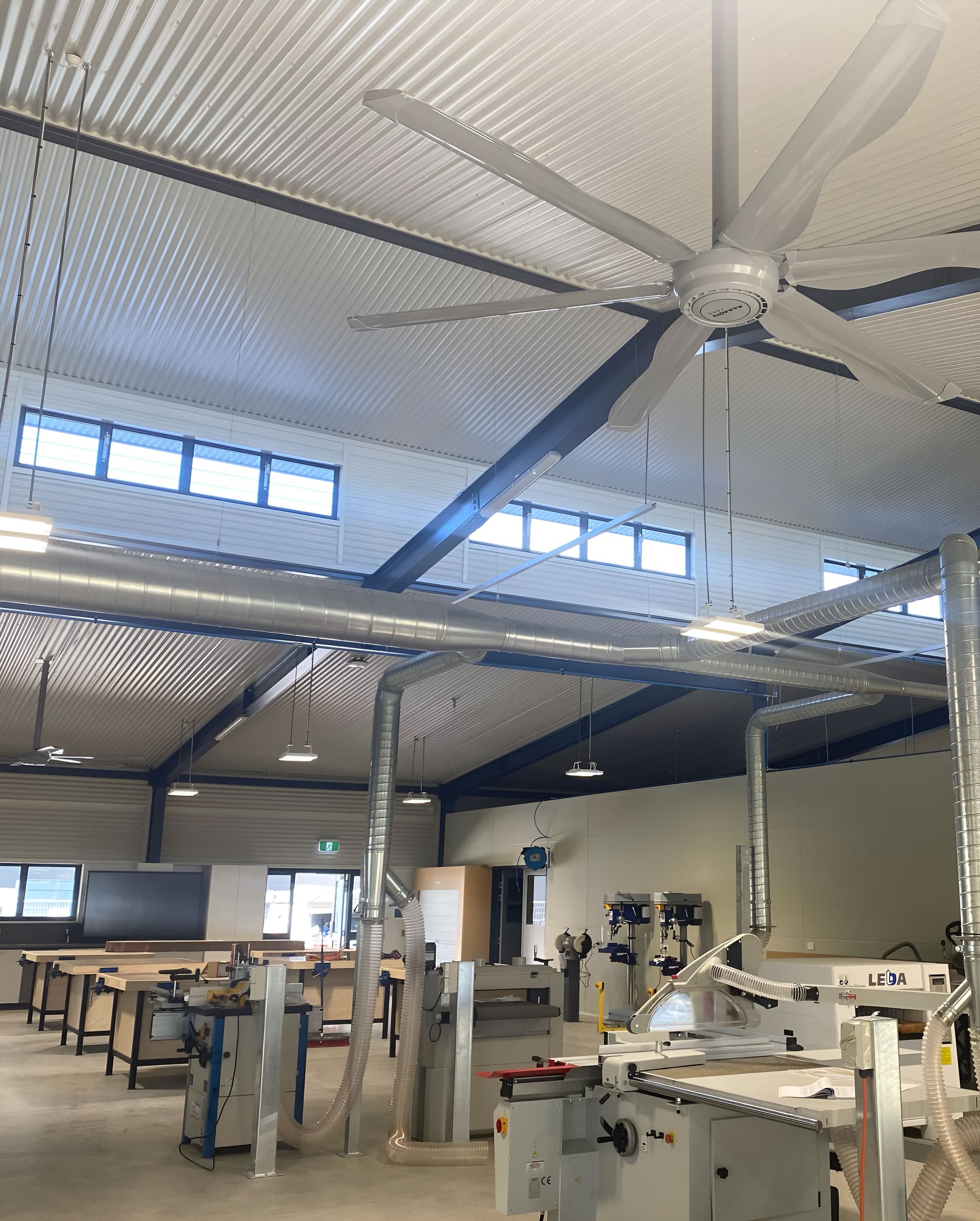 A Large Ceiling Fan Is Hanging From The Ceiling Of A Building  — Waltlec Industries In Garbutt, QLD