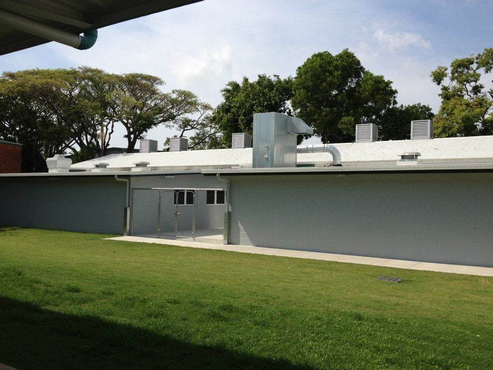 A White Building With A Roof That Has Trees In The Background — Waltlec Industries In Garbutt, QLD
