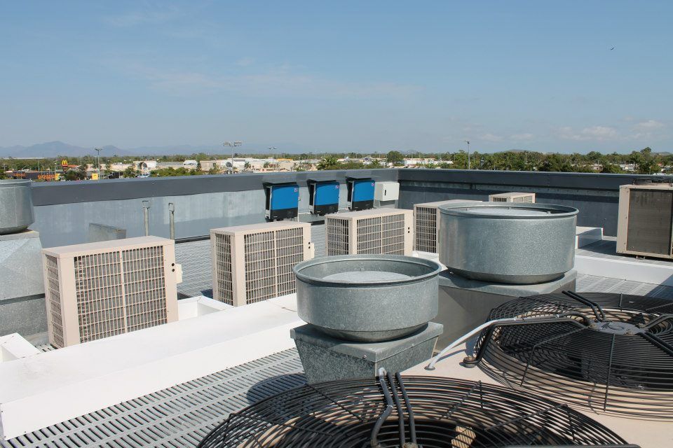 A Rooftop With A Lot Of Air Conditioners On It — Waltlec Industries In Garbutt, QLD