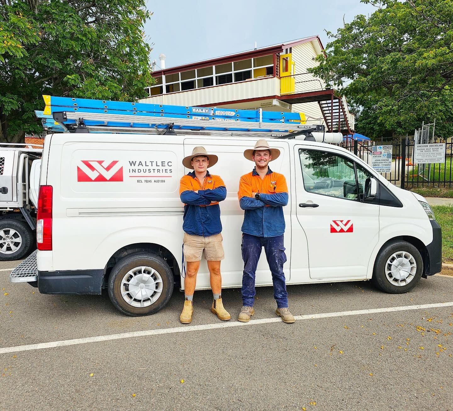 Two Men Are Standing Next To A White Van — Waltlec Industries In Garbutt, QLD