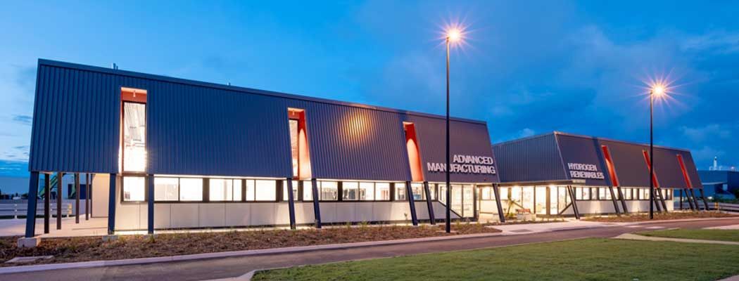 A Large Building with A Lot of Windows Is Lit up At Night — Waltlec Industries In Garbutt, QLD