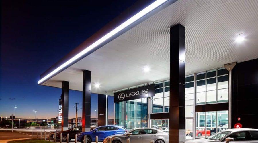 A Lexus Dealership with Cars Parked in Front of It at Night — Waltlec Industries In Garbutt, QLD