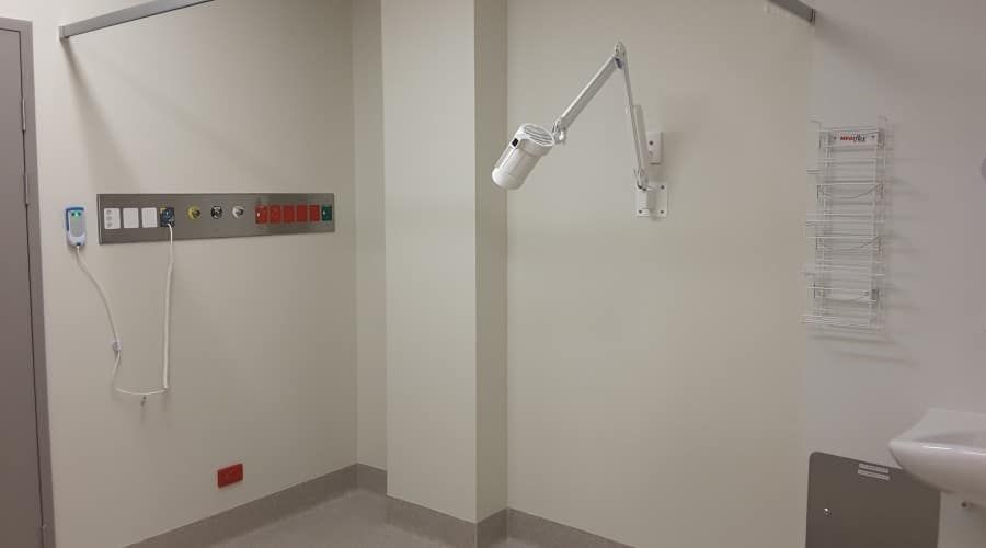 A Hospital Room with A Light on The Wall and A Sink — Waltlec Industries In Garbutt, QLD