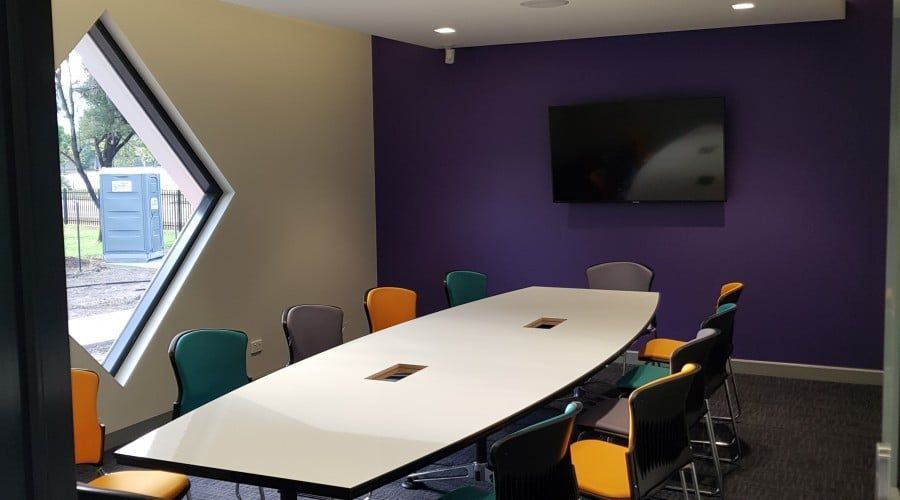 A Conference Room with A Long Table and Chairs and A Television on The Wall — Waltlec Industries In Garbutt, QLD