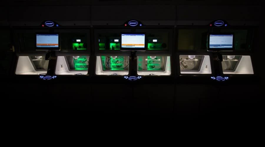 A Row of Computers with Green Lights on Them in A Dark Room — Waltlec Industries In Garbutt, QLD