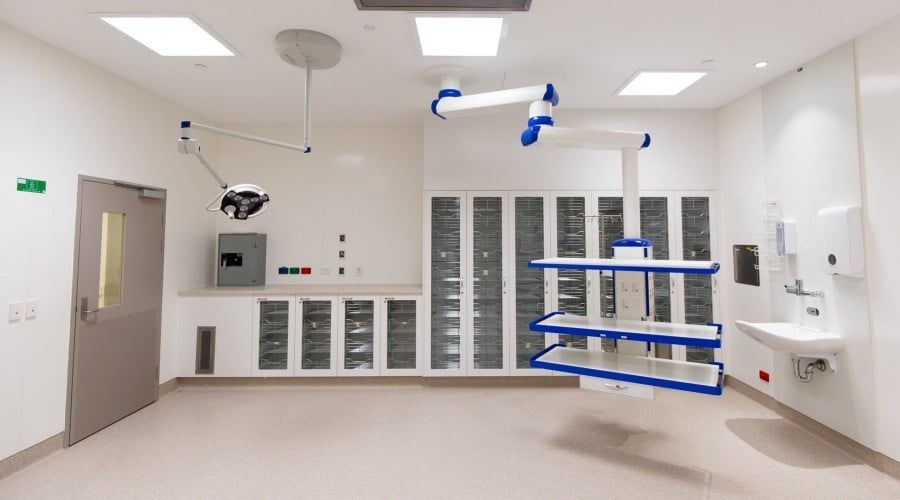 An Empty Operating Room with A Sink and Shelves Hanging from The Ceiling — Waltlec Industries In Garbutt, QLD