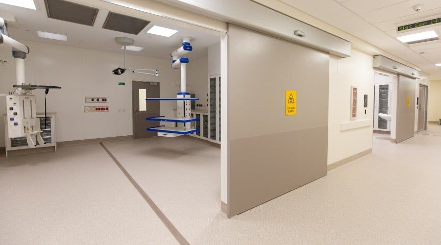 A Hospital Hallway with A Sliding Door Between Two Rooms — Waltlec Industries In Garbutt, QLD