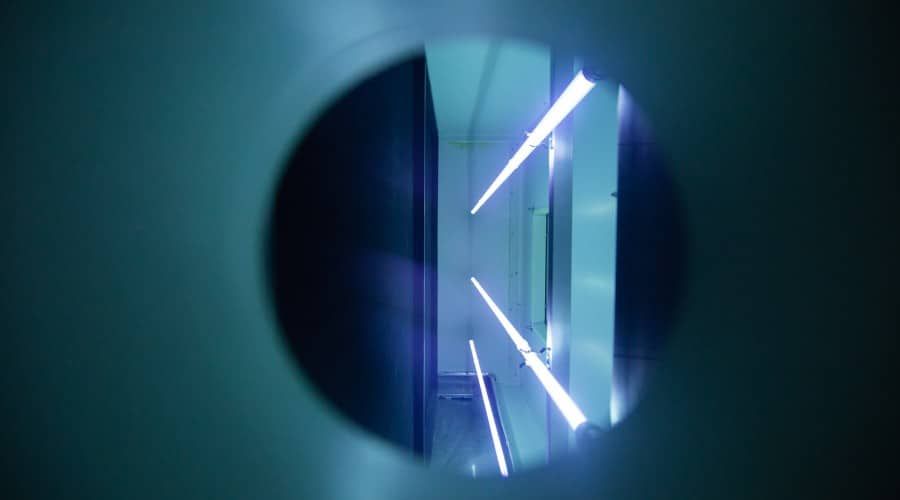 A Blue Light Is Shining Through a Hole in A Wall — Waltlec Industries In Garbutt, QLD