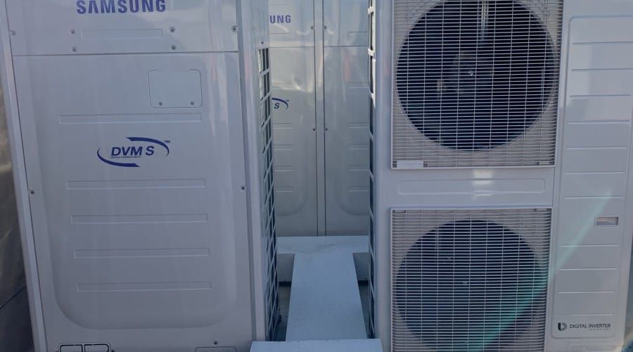 A Samsung Air Conditioner Is Sitting on Top of A White Table — Waltlec Industries In Garbutt, QLD