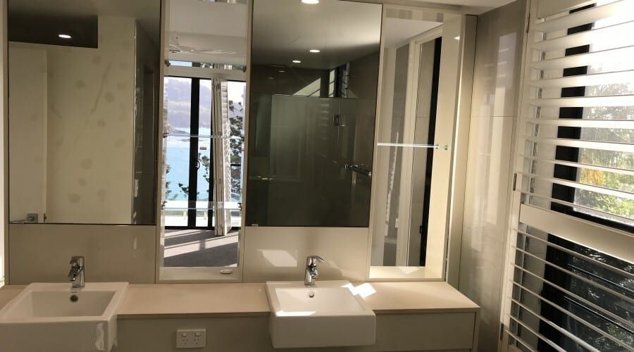 A Bathroom with Two Sinks and A Large Mirror — Waltlec Industries In Garbutt, QLD