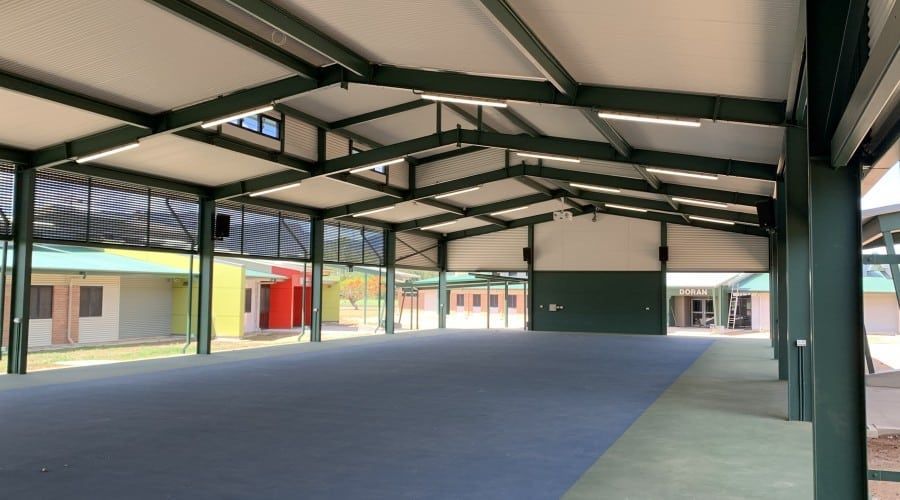 A Large Empty Room with A Blue Carpet and A Green Roof — Waltlec Industries In Garbutt, QLD