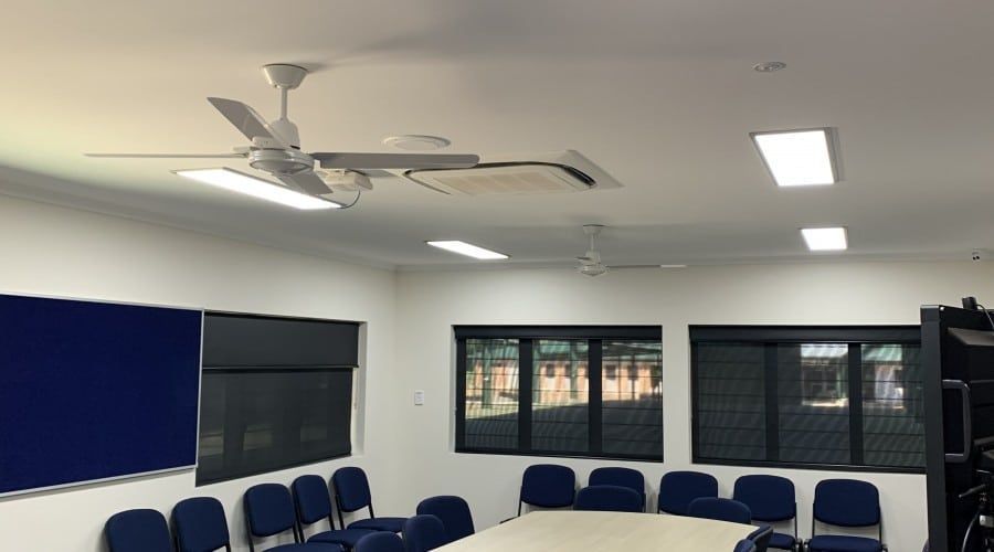 A Conference Room with A Table and Chairs and A Ceiling Fan — Waltlec Industries In Garbutt, QLD