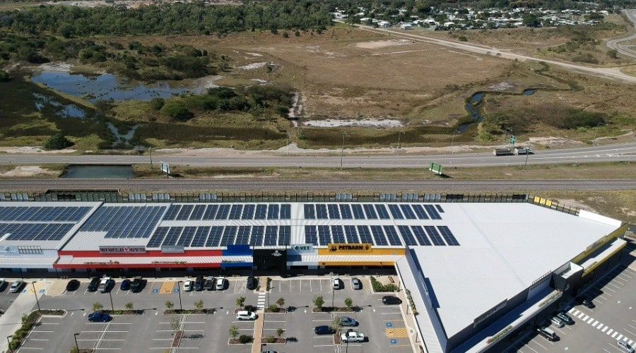 An Aerial View of A Shopping Mall with Solar Panels on The Roof — Waltlec Industries In Garbutt, QLD