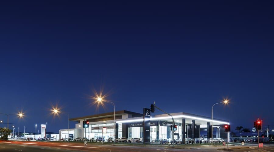 A Gas Station Is Lit up At Night with A Blue Sky in The Background — Waltlec Industries In Garbutt, QLD
