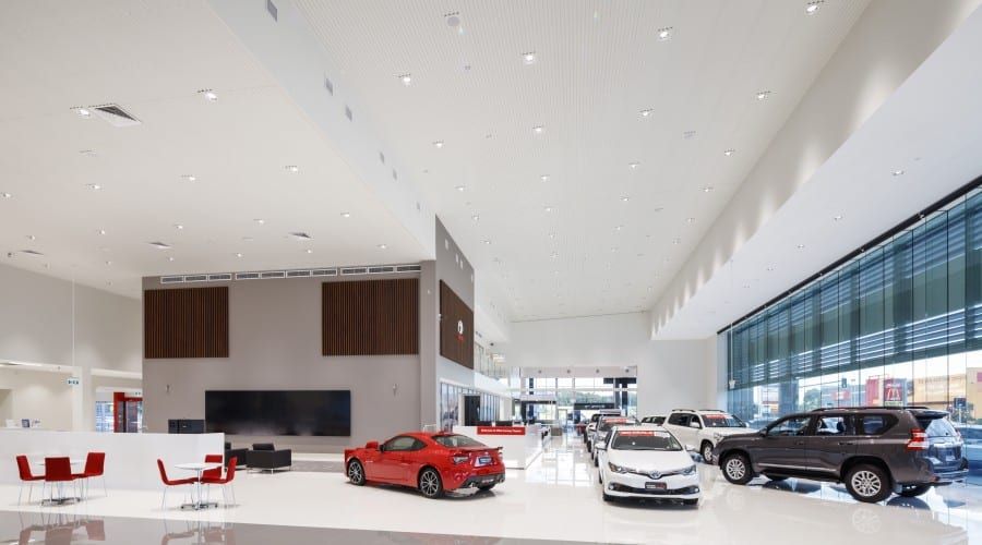 A Showroom with A Lot of Cars on Display Including a Red Sports Car — Waltlec Industries In Garbutt, QLD