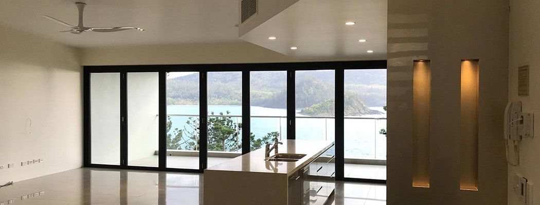 A Living Room with A Lot of Windows and A View of The Ocean — Waltlec Industries In Garbutt, QLD