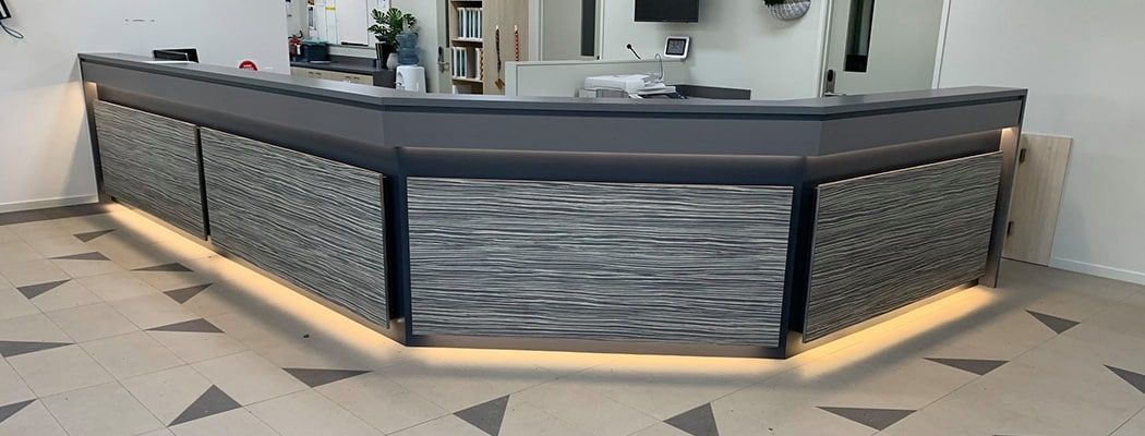 A Long Reception Desk in A Room with A Tiled Floor — Waltlec Industries In Garbutt, QLD