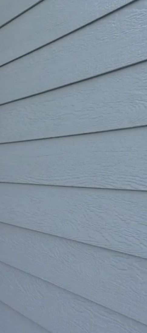 A close up of a light blue LP siding on a house.