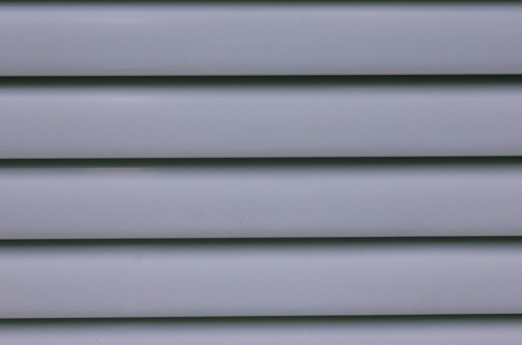 A close up of a gray vinyl siding on a house.