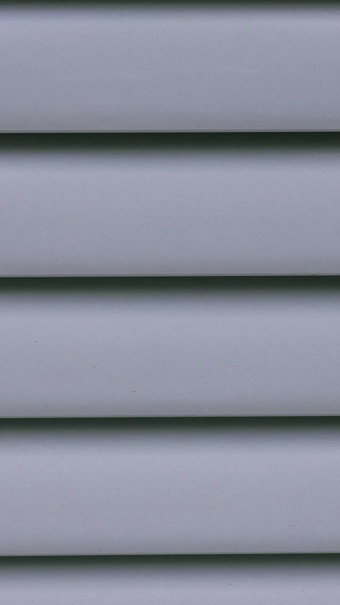 A close up of a gray vinyl siding on a house.