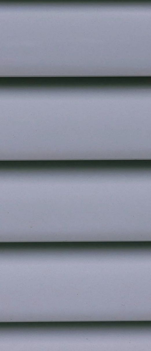 A close up of a gray vinyl siding on a house.
