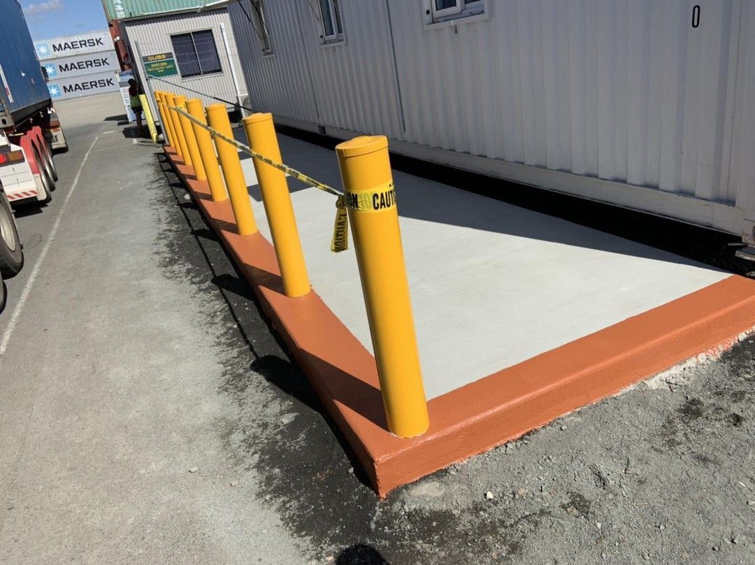 A Row of Yellow Poles on The Side of A Road — Pedro's Concreting in Pittsworth, QLD