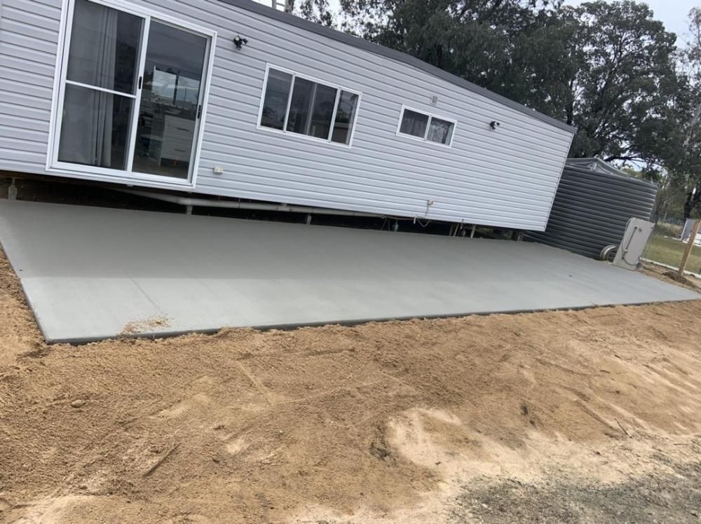 A Mobile Home is Sitting on Top of a Concrete Driveway — Pedro's Concreting in Pittsworth, QLD
