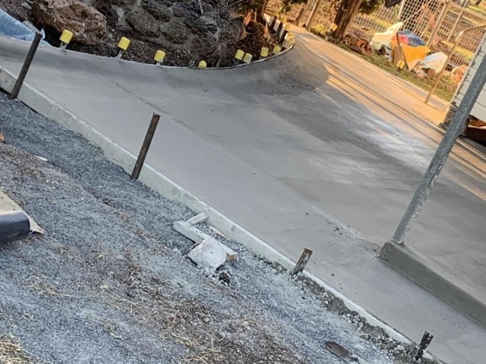A Concrete Curb is Being Installed on the Side of a Road — Pedro's Concreting in Pittsworth, QLD