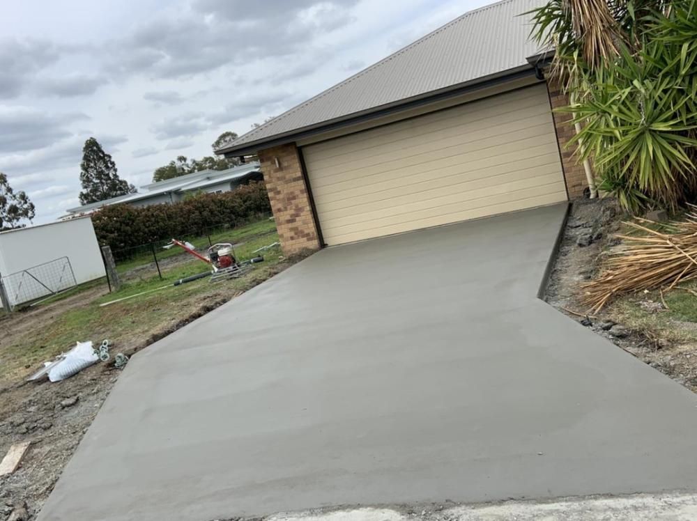 Concrete Driveway Leading to a Large Garage — Pedro's Concreting in Toowoomba, QLD