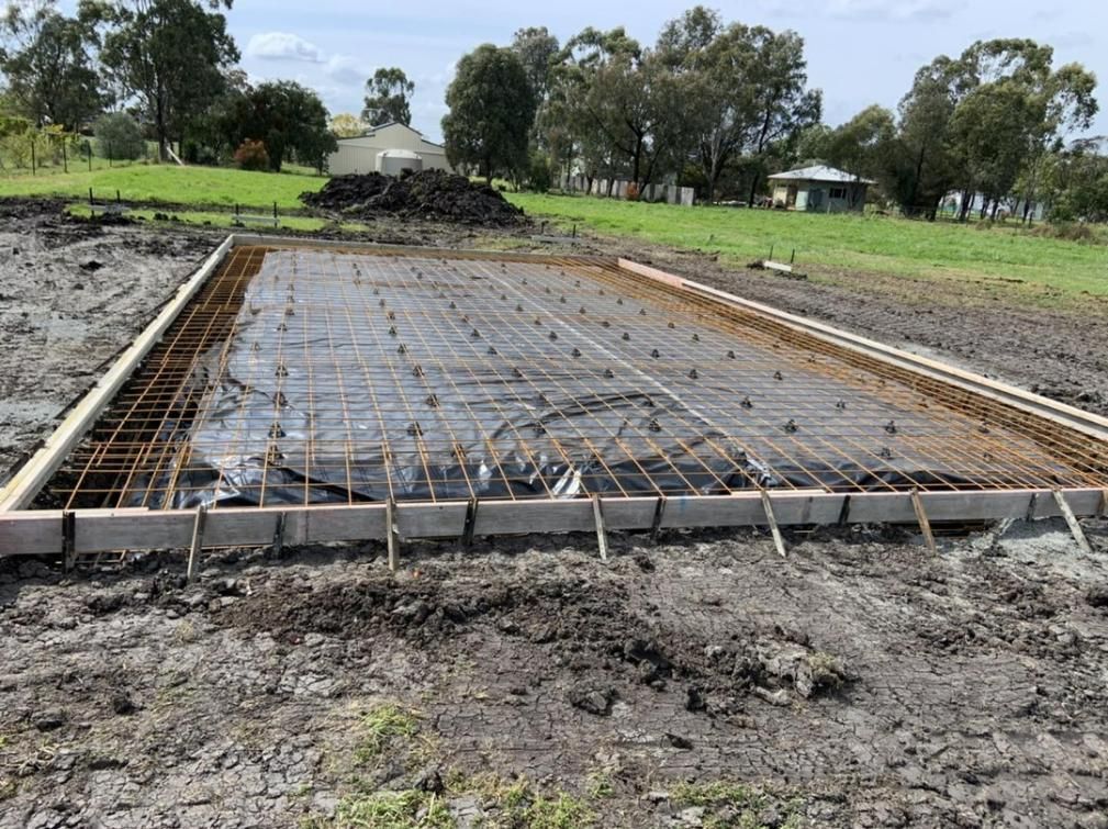 A Concrete Slab Is Being Built in A Field with Trees in The Background  — Pedro's Concreting in Highfields, QLD