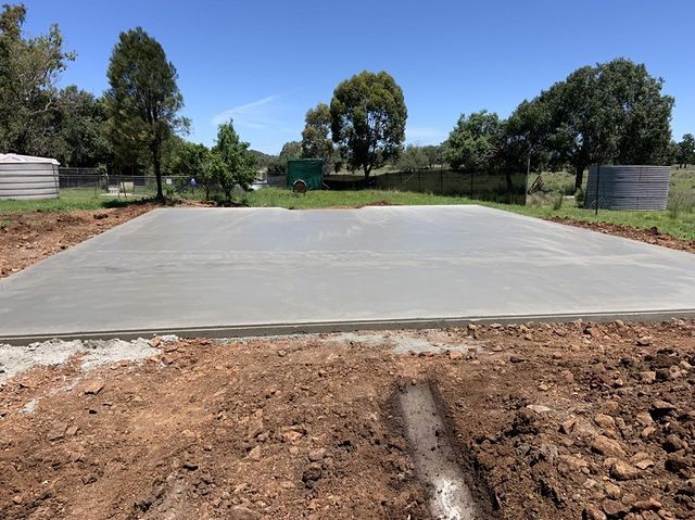 Large Concrete Slab Sitting in the Middle of a Dirt Field — Pedro's Concreting in Toowoomba, QLD